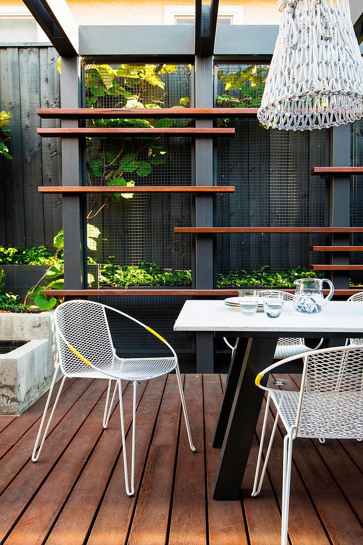 Modern garden furniture on the covered terrace with wooden deck