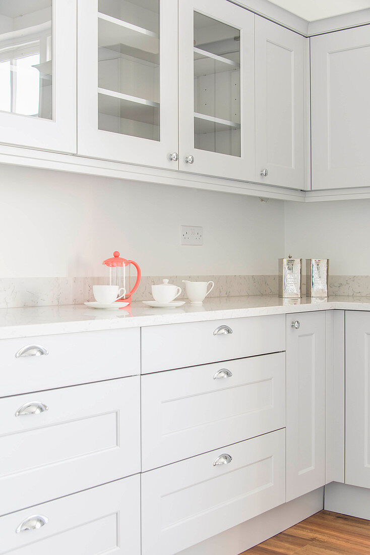 Cafetiere and cups in pale grey kitchen