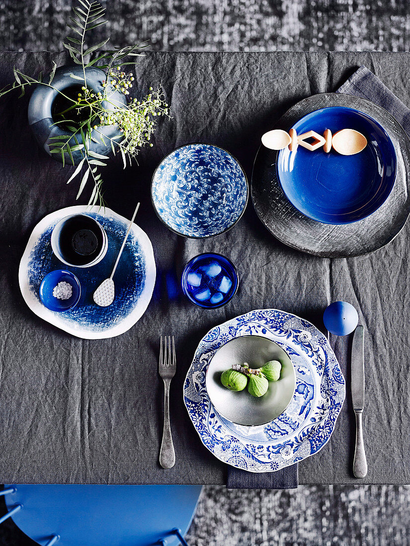 Blue and white place setting on anthracite-colored table
