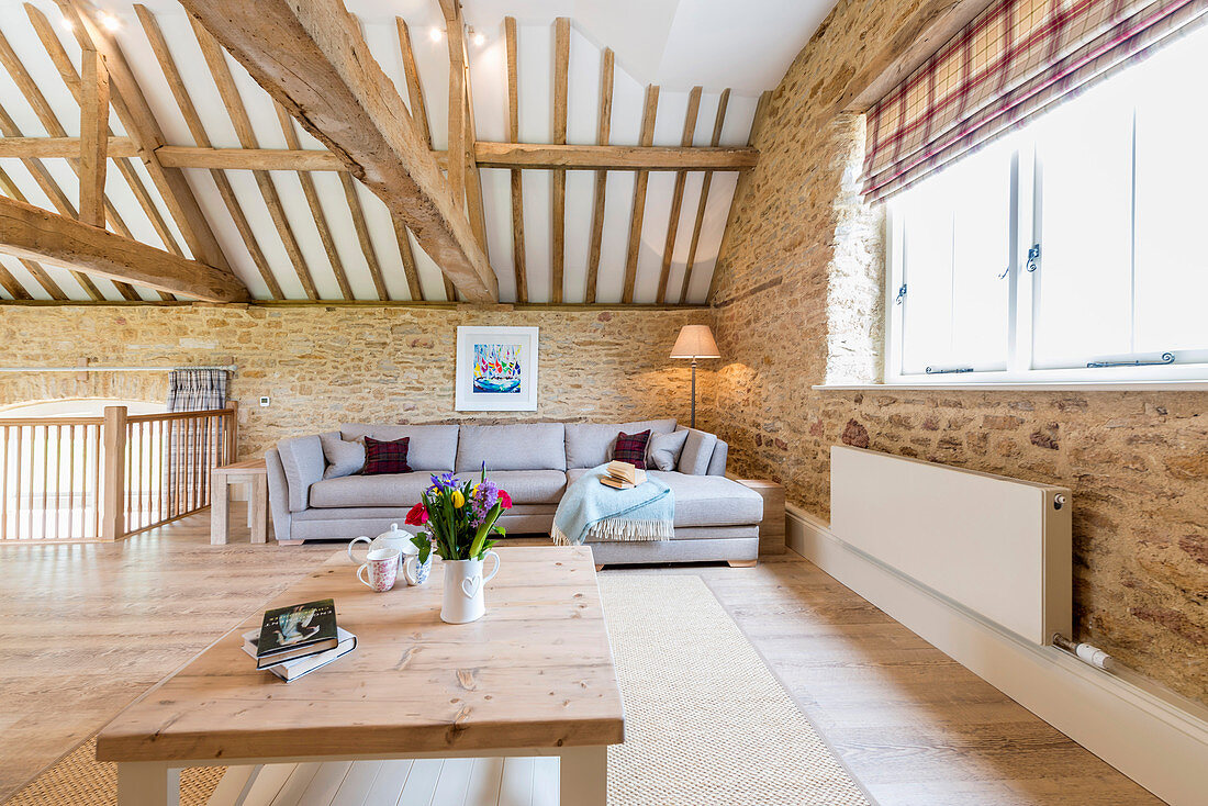 Living area below exposed roof structure in converted barn