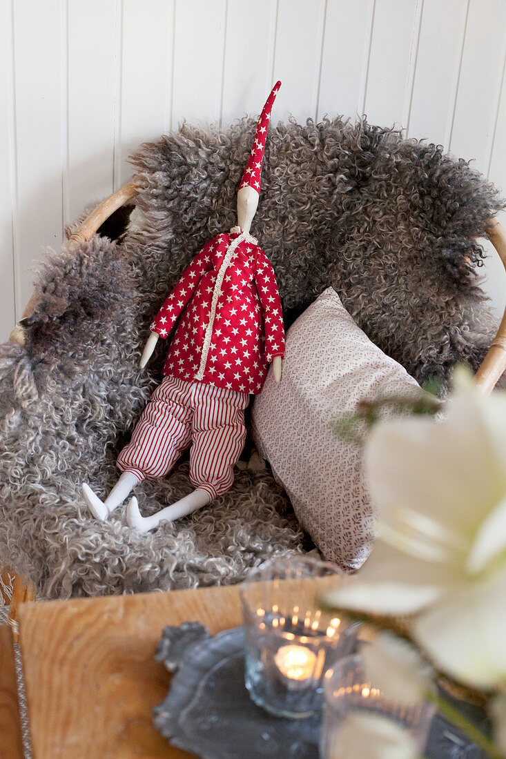 Sheepskin blanket and Christmas decoration on armchair