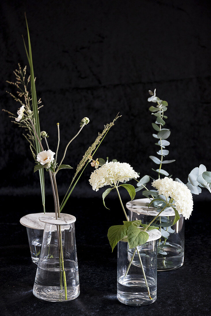 Blumenarrangement in Vasen mit Aufsätzen aus Modelliermasse