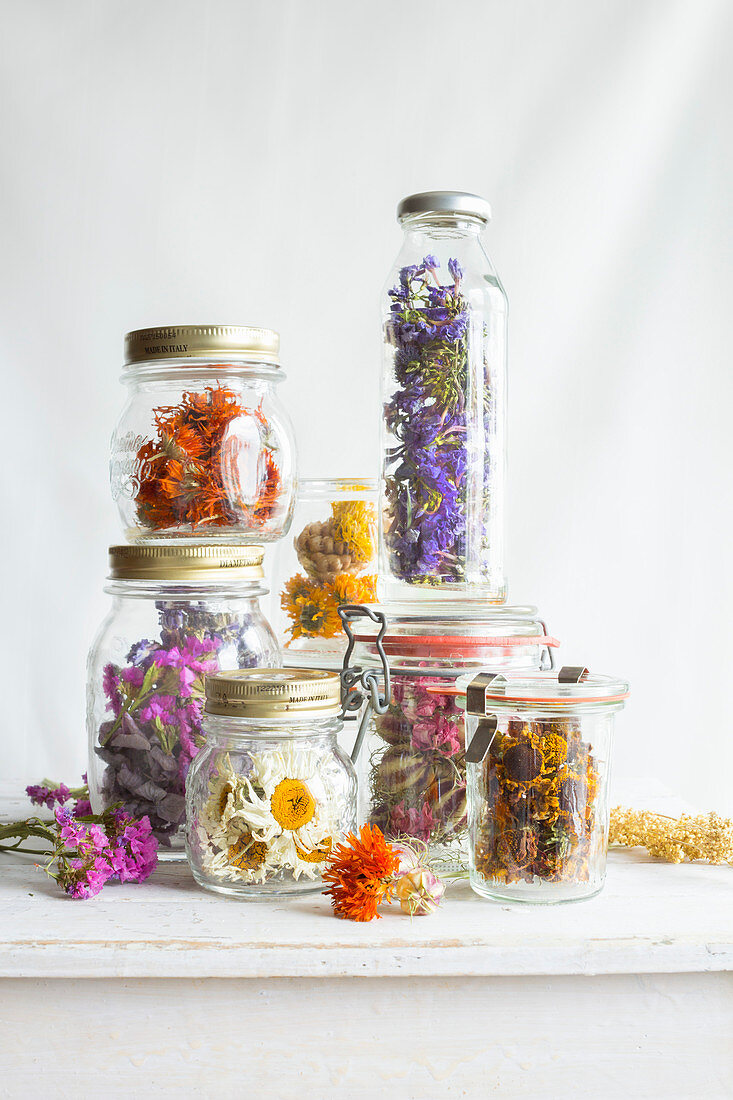 Dried flowers in screw-top jars and preserving jars