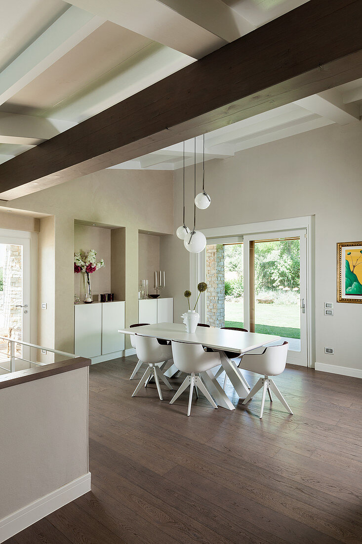 Modern dining room with high ceiling and beige walls