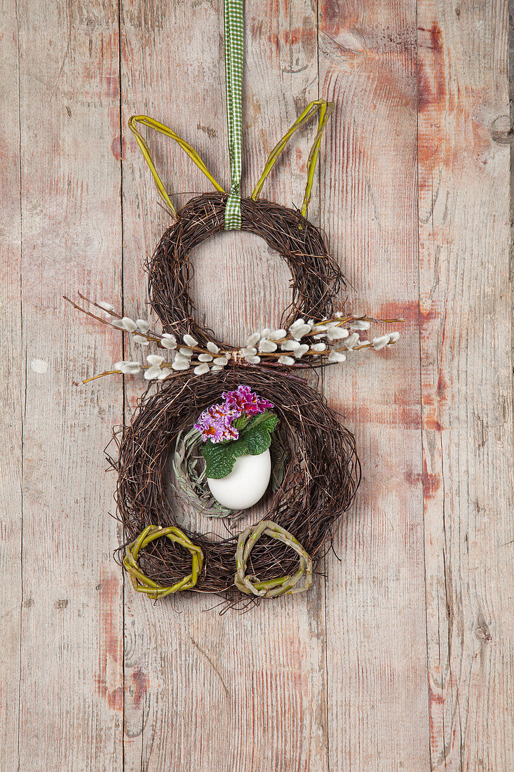 Easter bunny made from two wreaths of maidenhair vine tendrils on wall