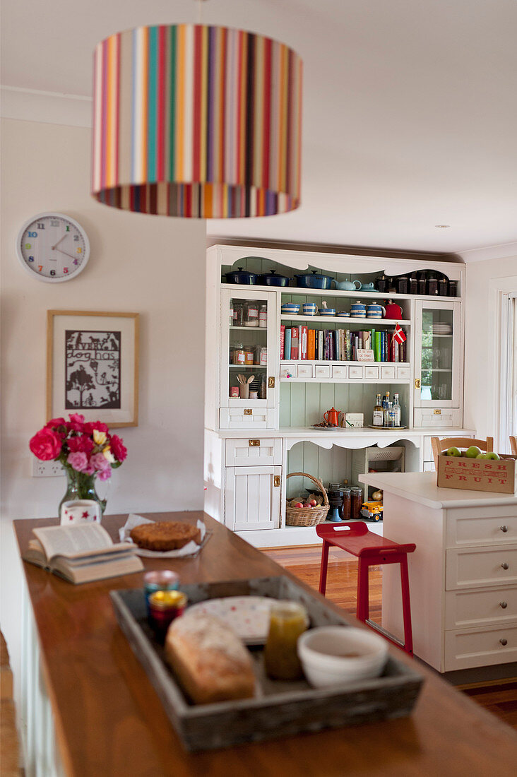 Striped ceiling lamp above counter in country-house kitchen