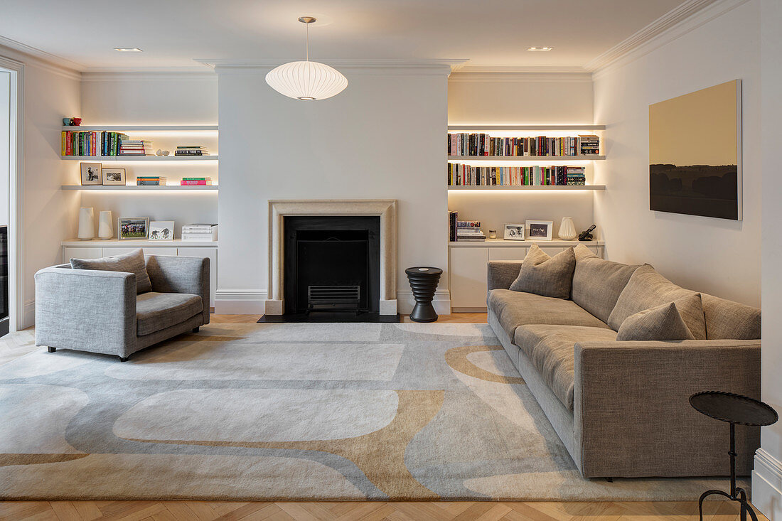 Living area with fireplace and pale grey sofa set