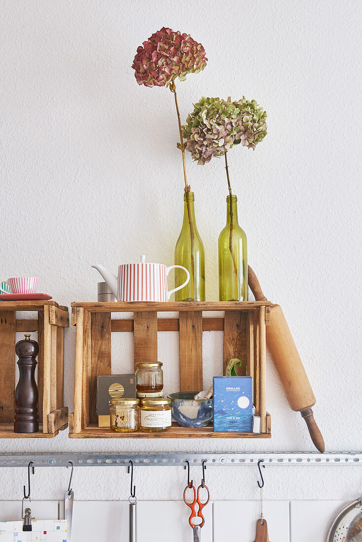 Old wooden wine crates used as wall-mounted shelves in kitchen