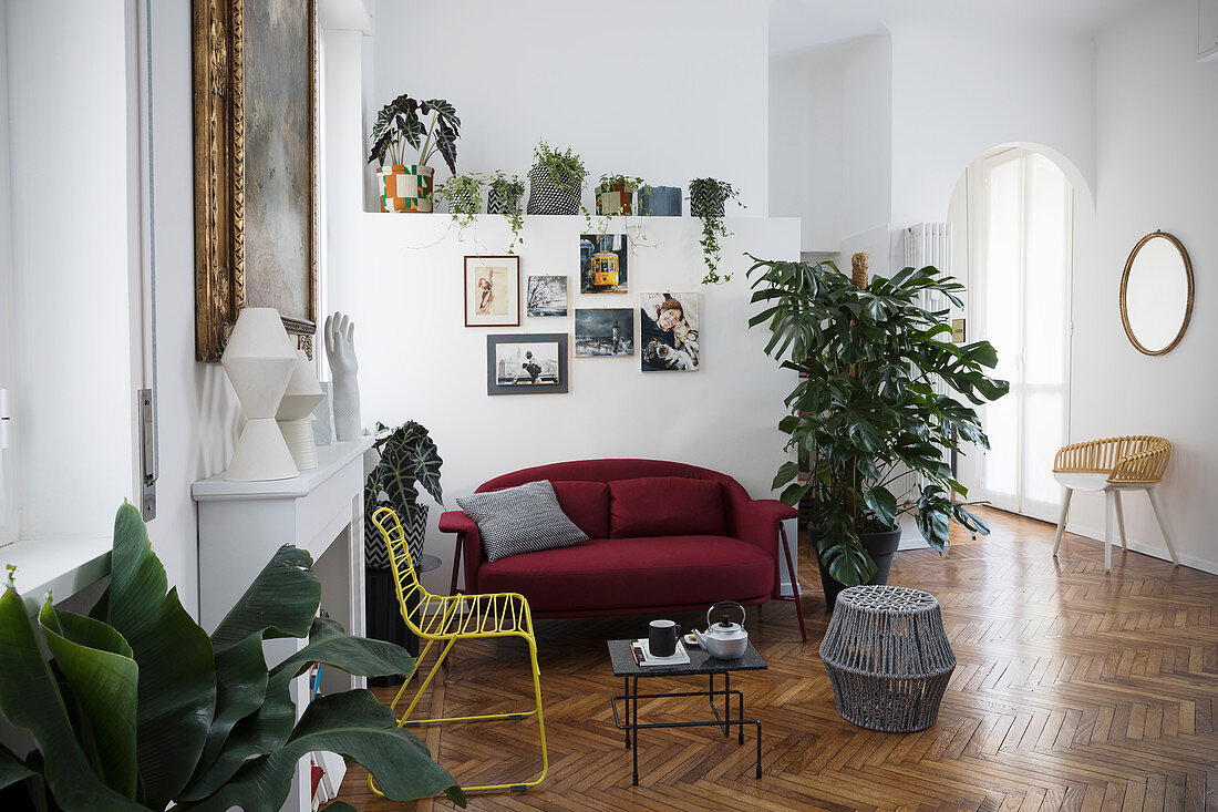 Eclectic living room with herringbone parquet floor in period apartment