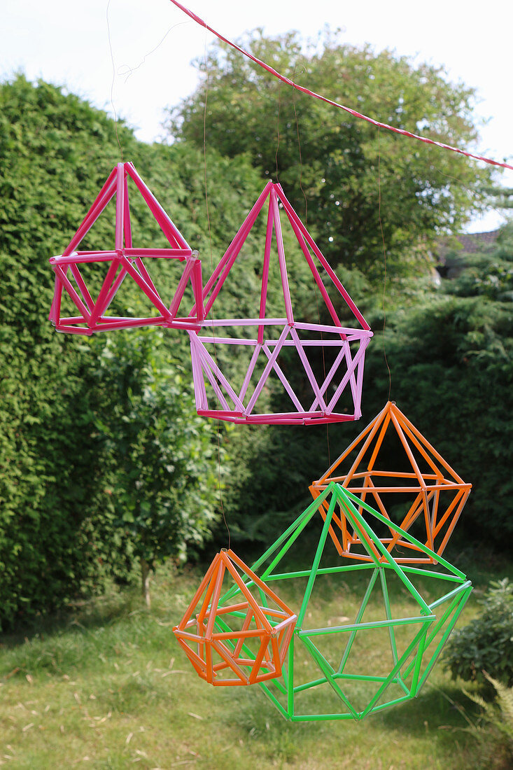 Geometric decorations made from colourful drinking straws in garden