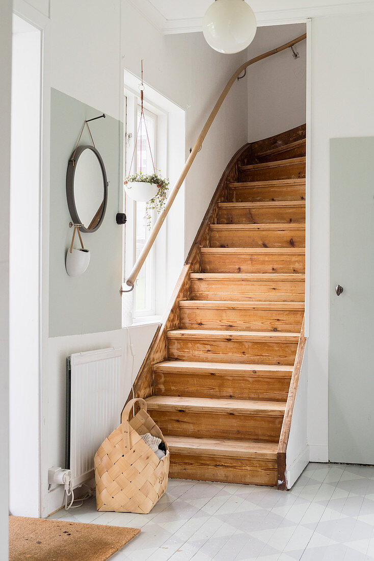 Old wooden staircase in country-house-style foyer