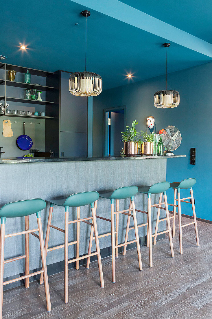 Extravagant, designer, open-plan kitchen in petrol blue and grey