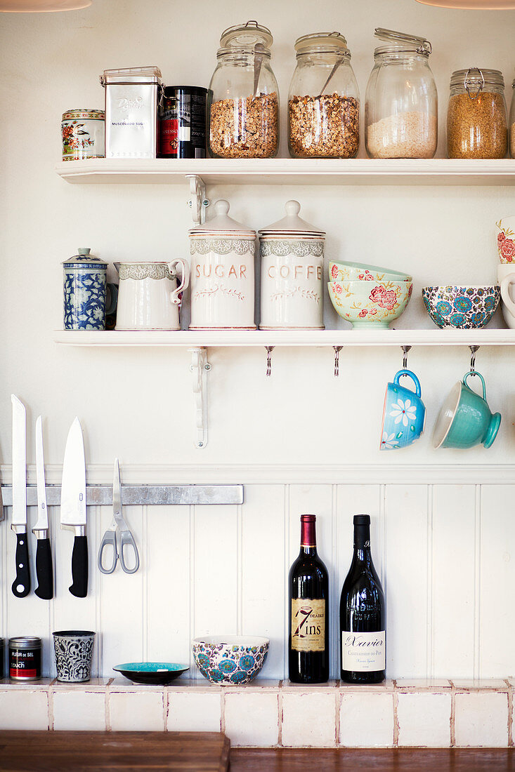 Storage jars and bowls on kitchen shelves