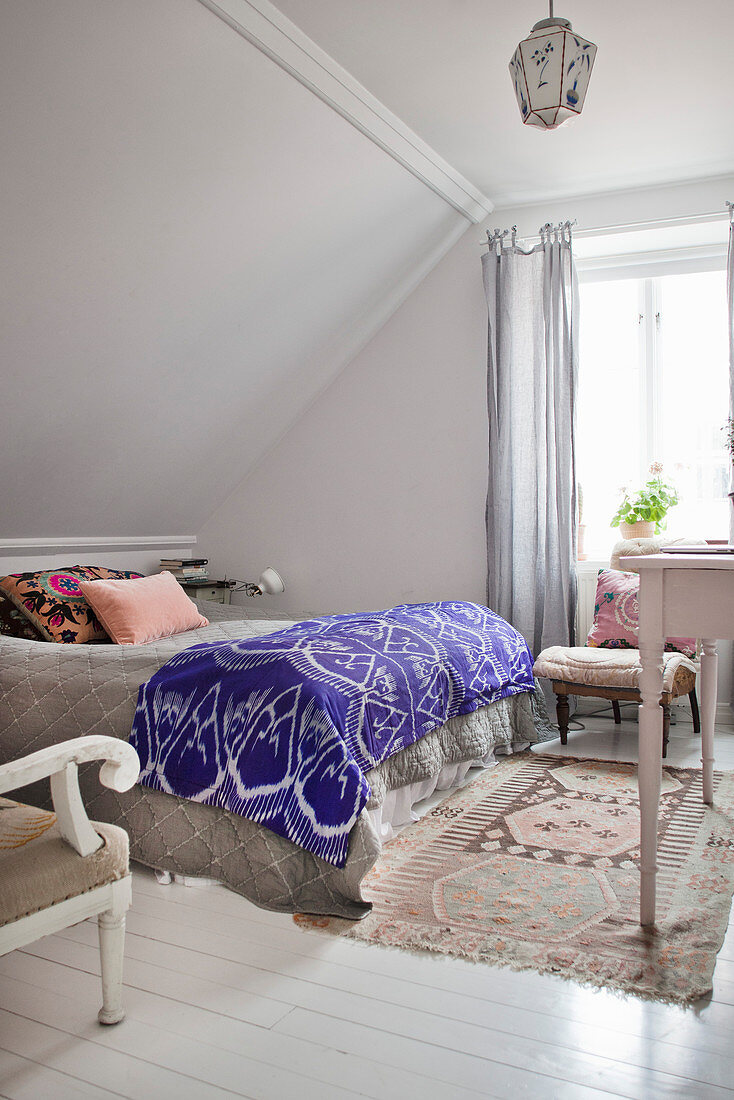 Bohemian-style bedroom with sloping ceiling