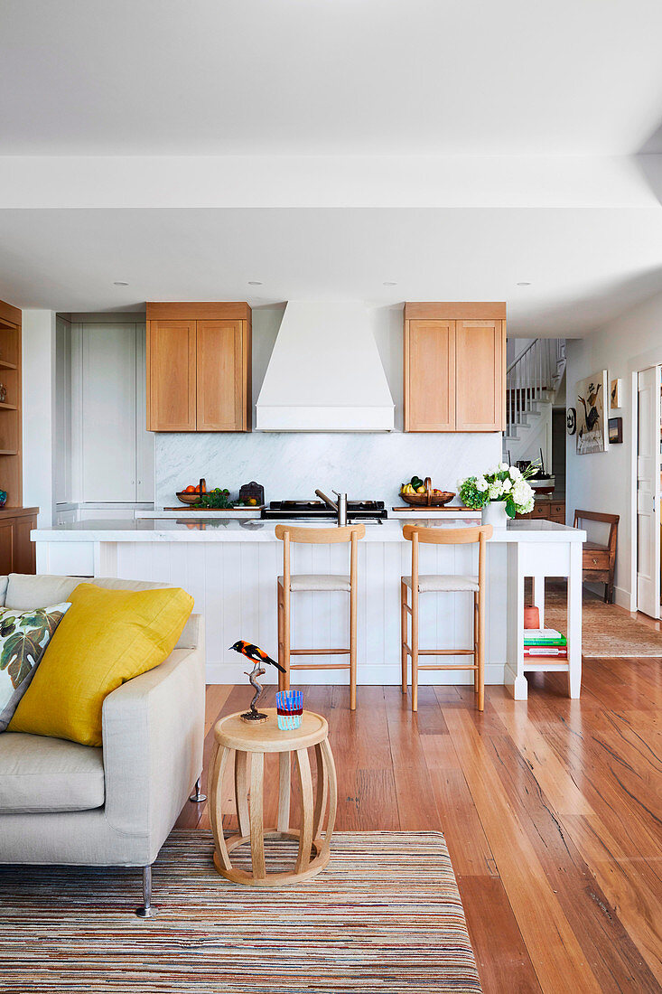 Small open kitchen area with bar stools at breakfast bar