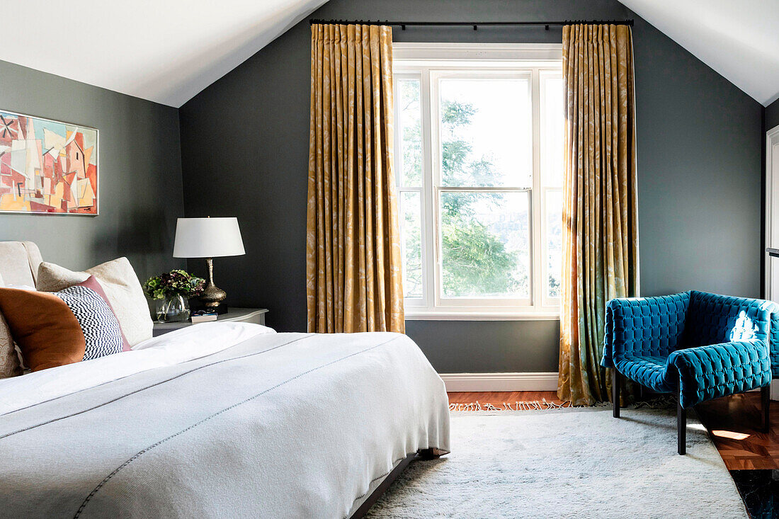 Bedroom under the sloping roof with gray walls