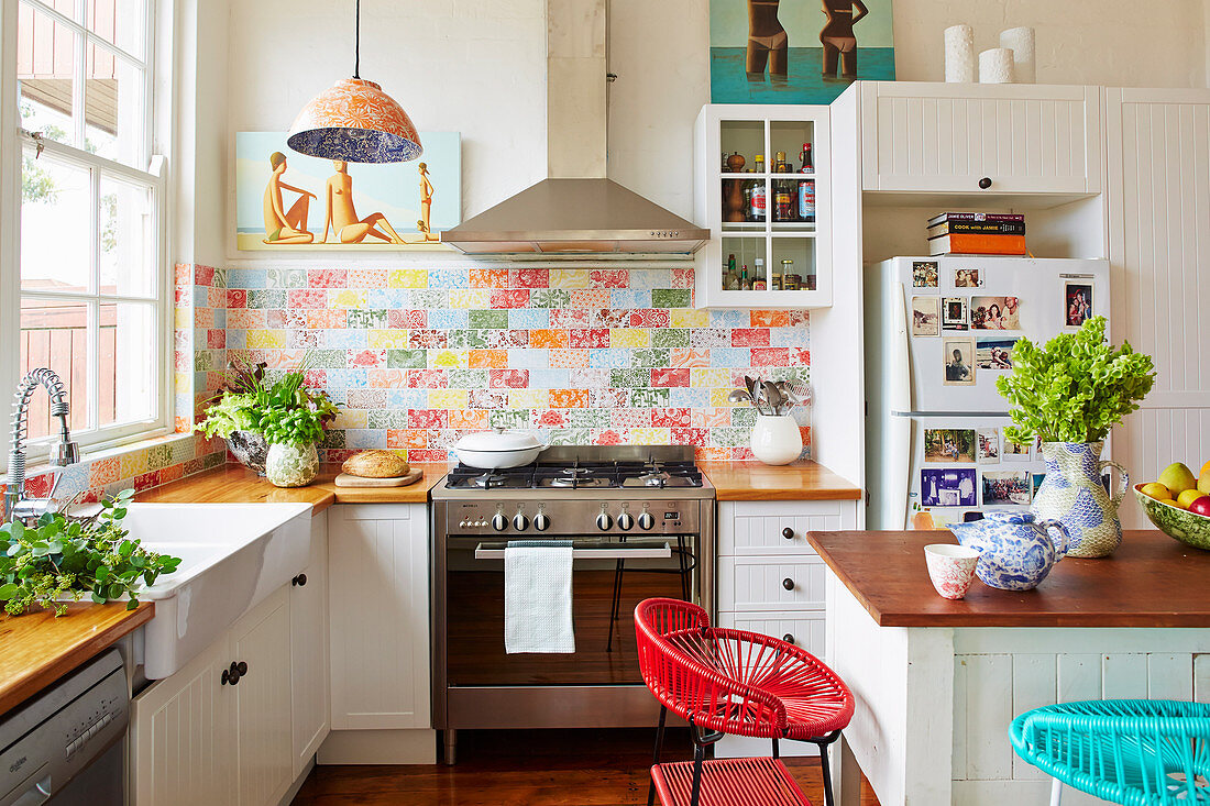 White fitted kitchen with wood worktop wood and colorful wall tiles