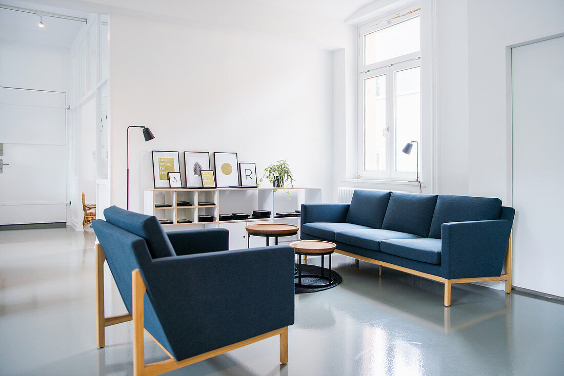 Blue sofa set in white living room in period apartment