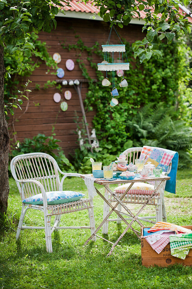 Set table in summery garden with colourful accessories