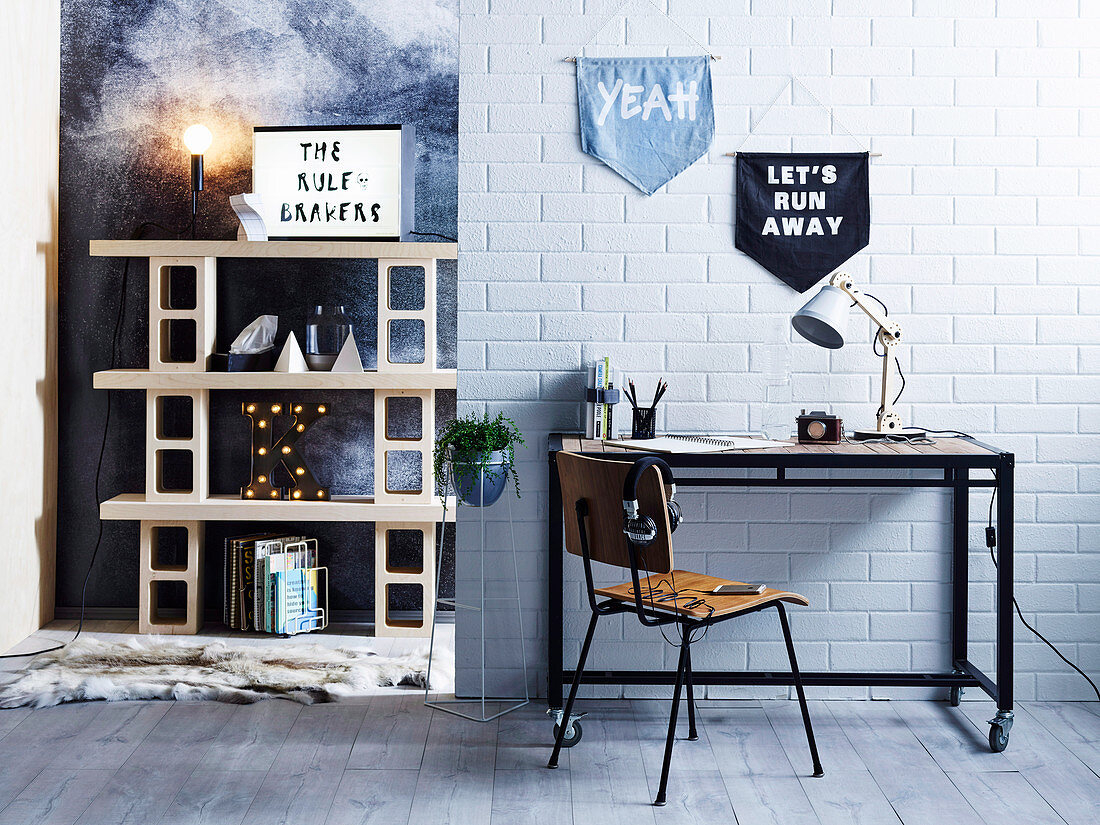 Industrial style desk on brick wall with pennants