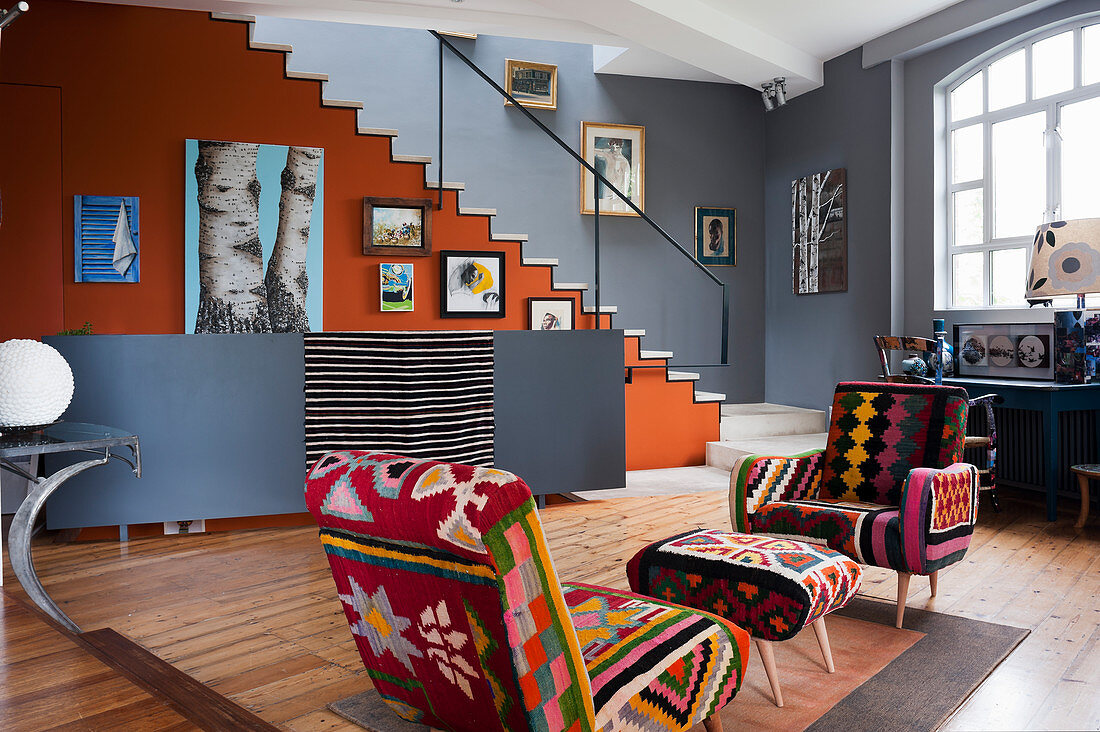 Kilim chairs in open-plan living space filled with assorted artwork