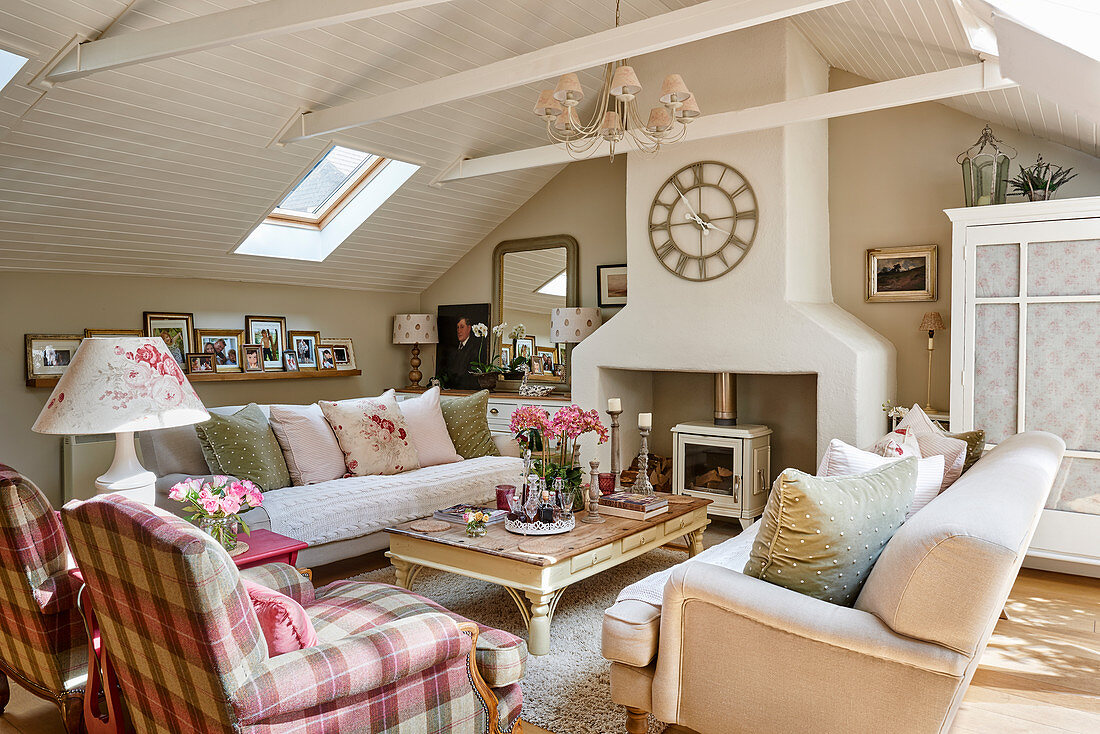 Fireplace, sofas and armchairs in attic living room