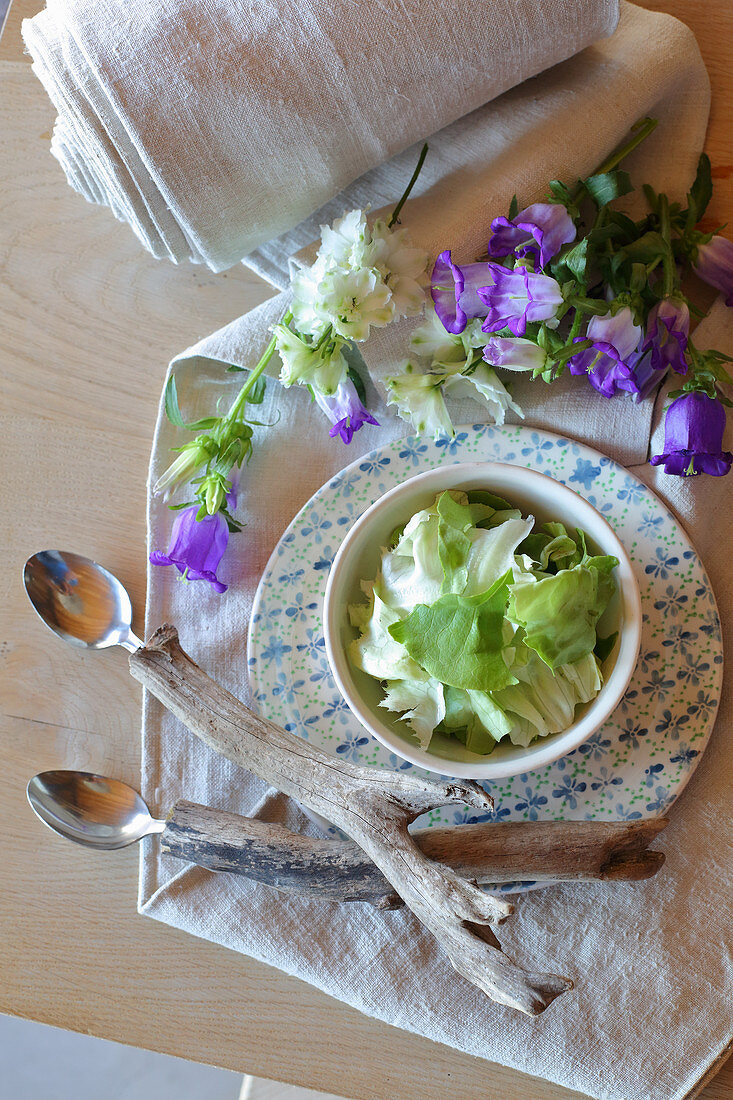Handmade spoons with driftwood handles on summer place setting