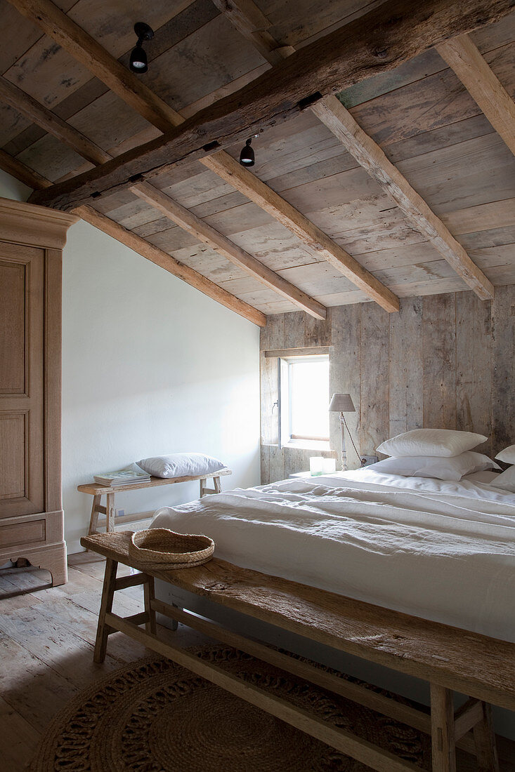 Rustic bedroom with wooden walls, floor and ceiling