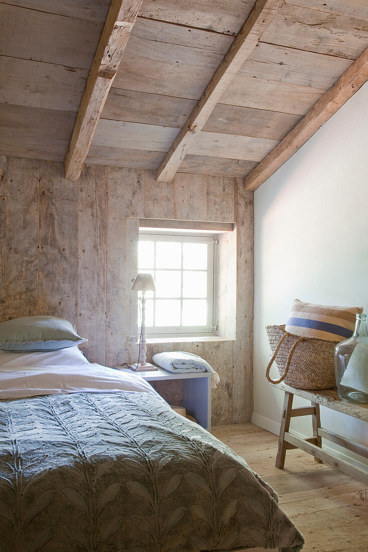 Rustic bedroom with wooden walls, floor and ceiling