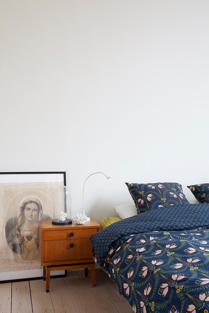 Picture of Madonna and bedside cabinet in mid-century modern style next to bed