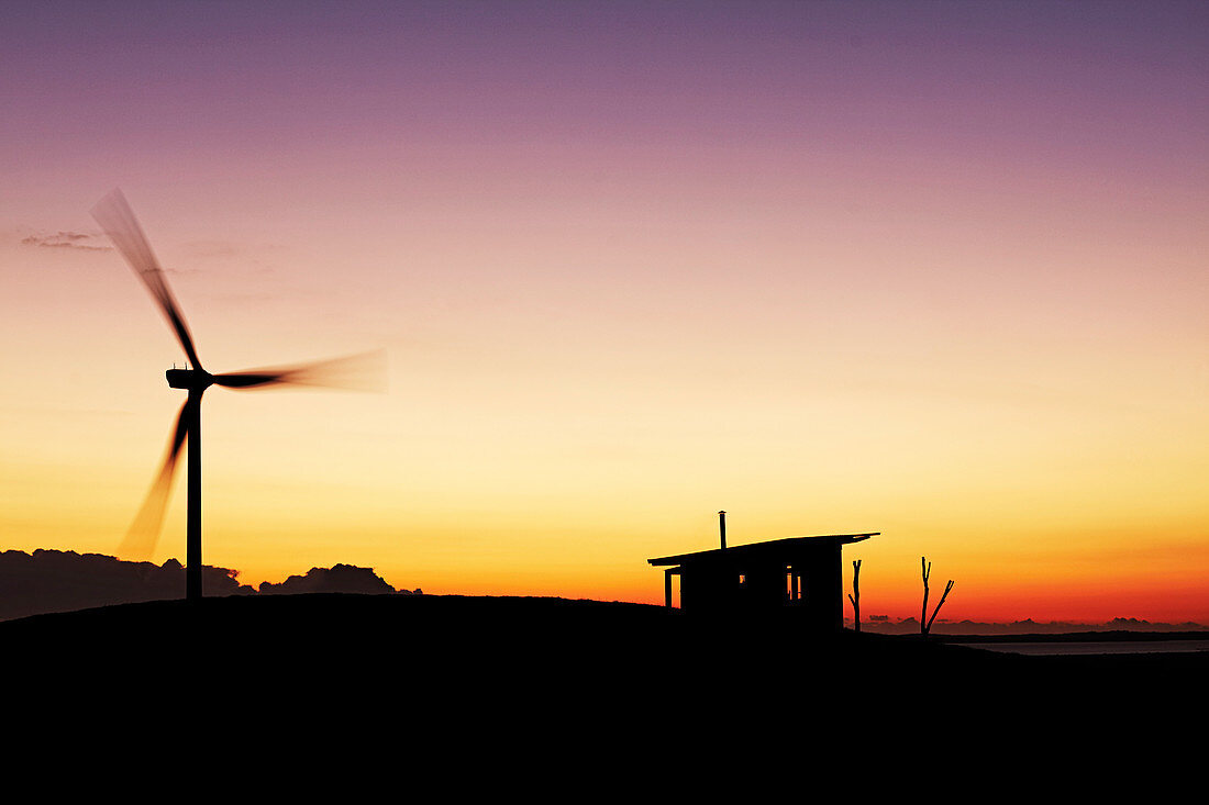 Windrad und Hütte bei Sonnenuntergang