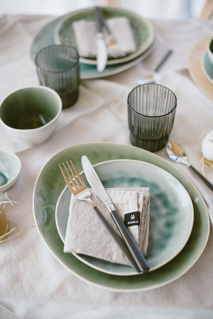 Table set with crockery in shades of blue and green