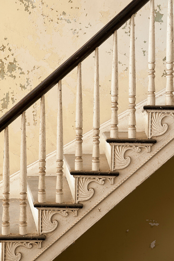 Old staircase with turned balusters in abandoned house