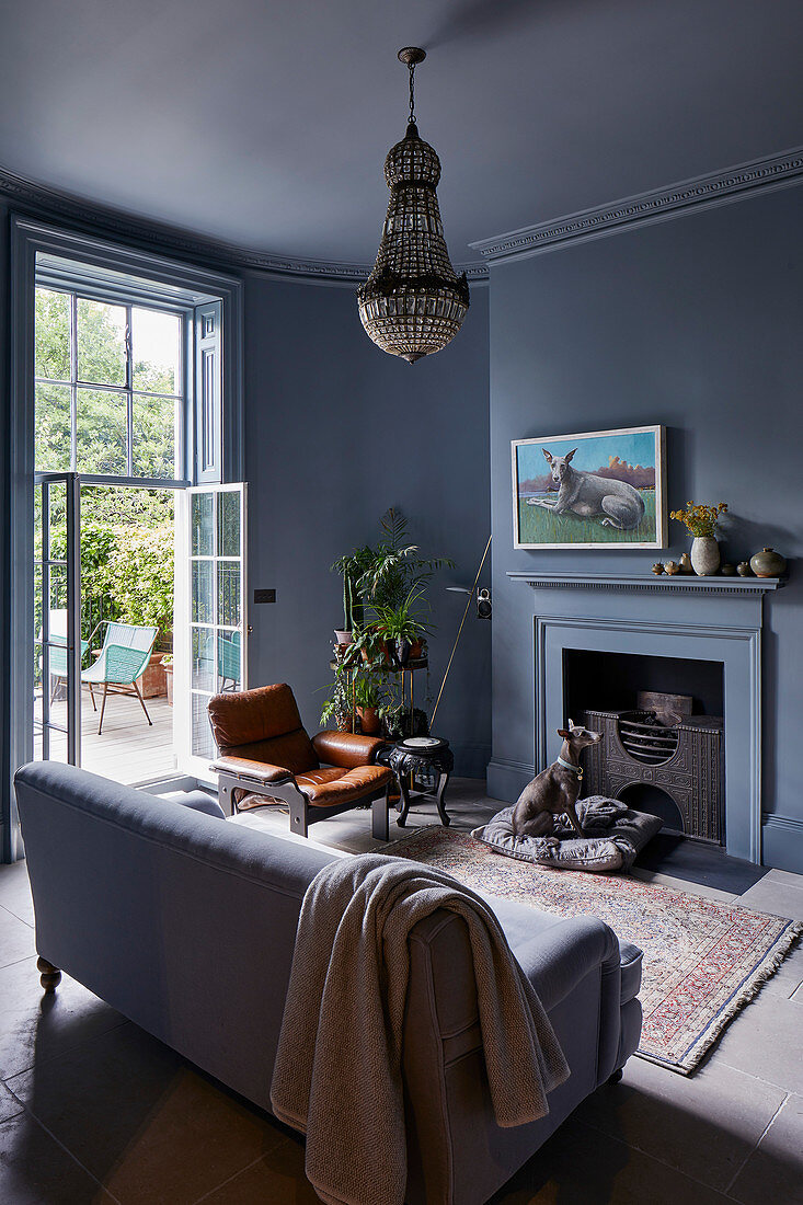 Sofa in front of open fireplace in classic grey living room