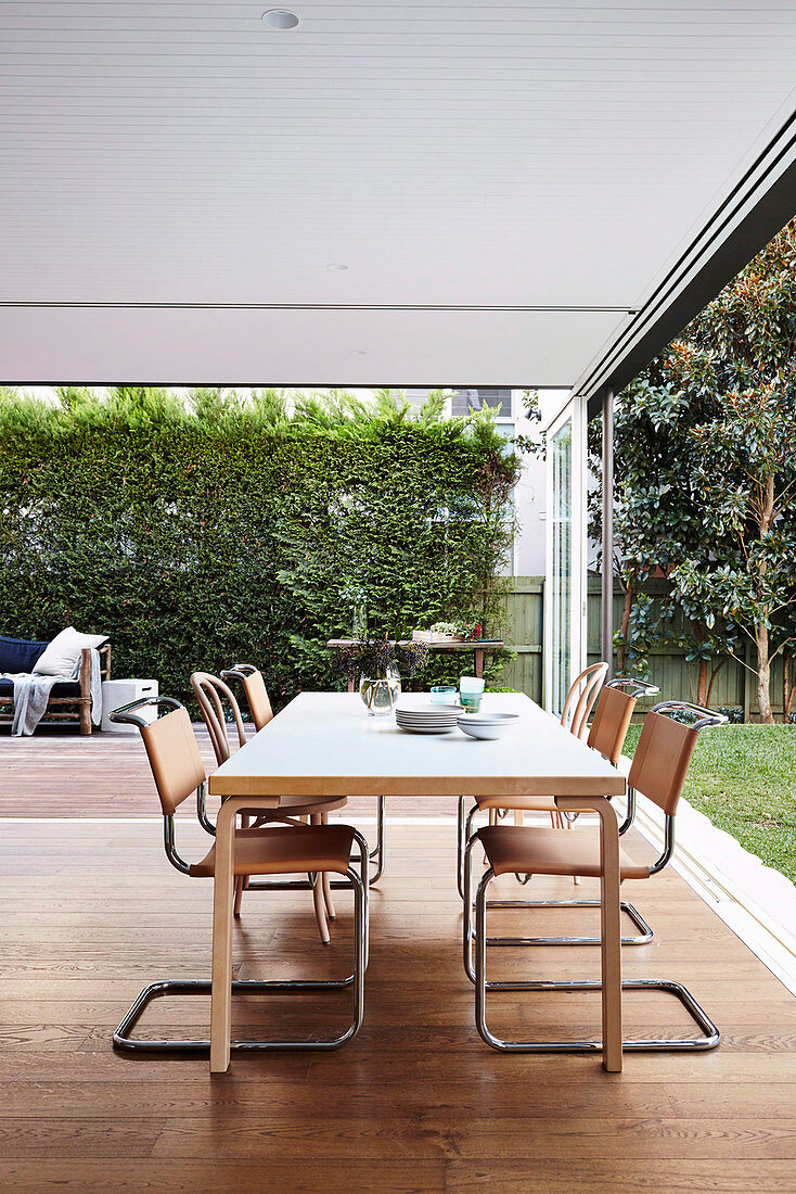 Dining area with cantilever chairs in front of all-round patio doors