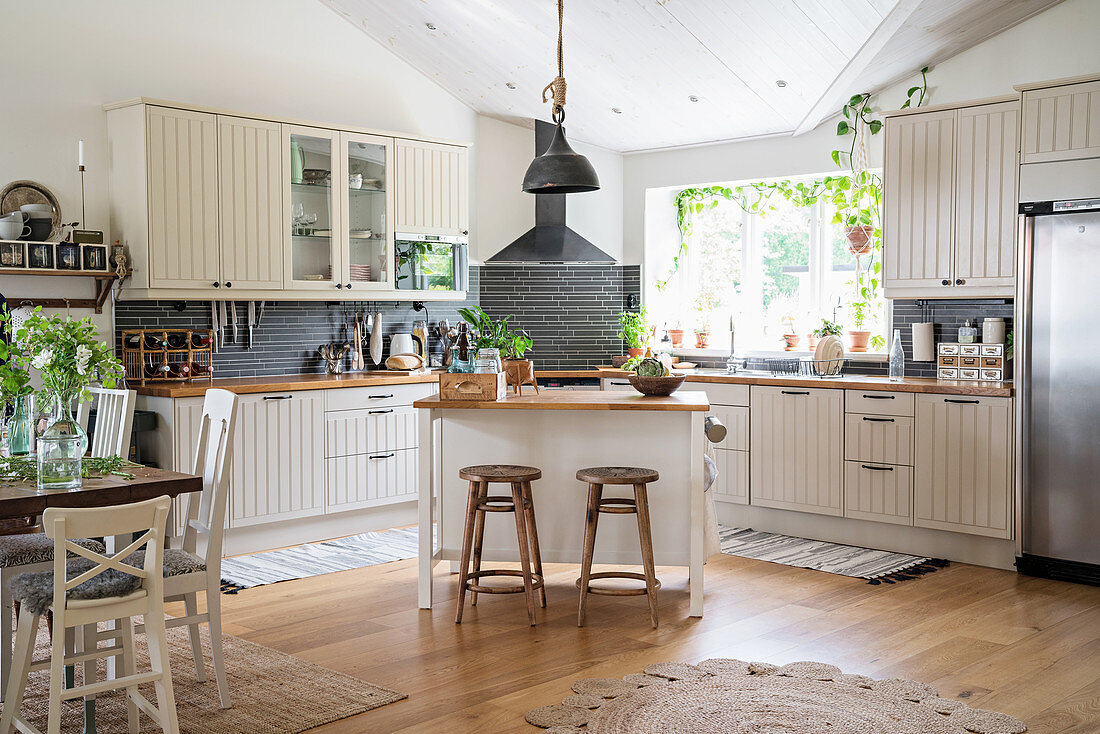 Large open-plan country-house kitchen in natural shades