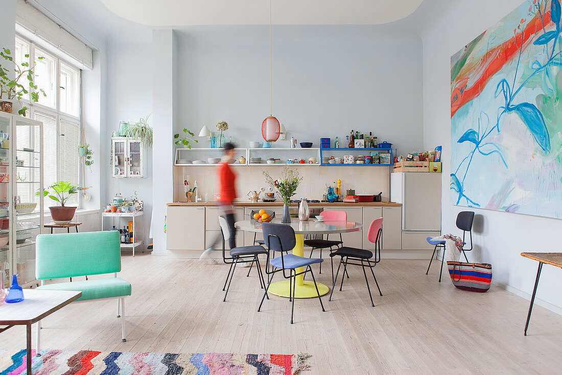 Colourful retro furniture in open-plan kitchen-dining room of period building