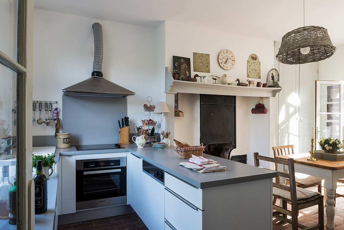 Silestone worktops in compact kitchen with basket lampshade