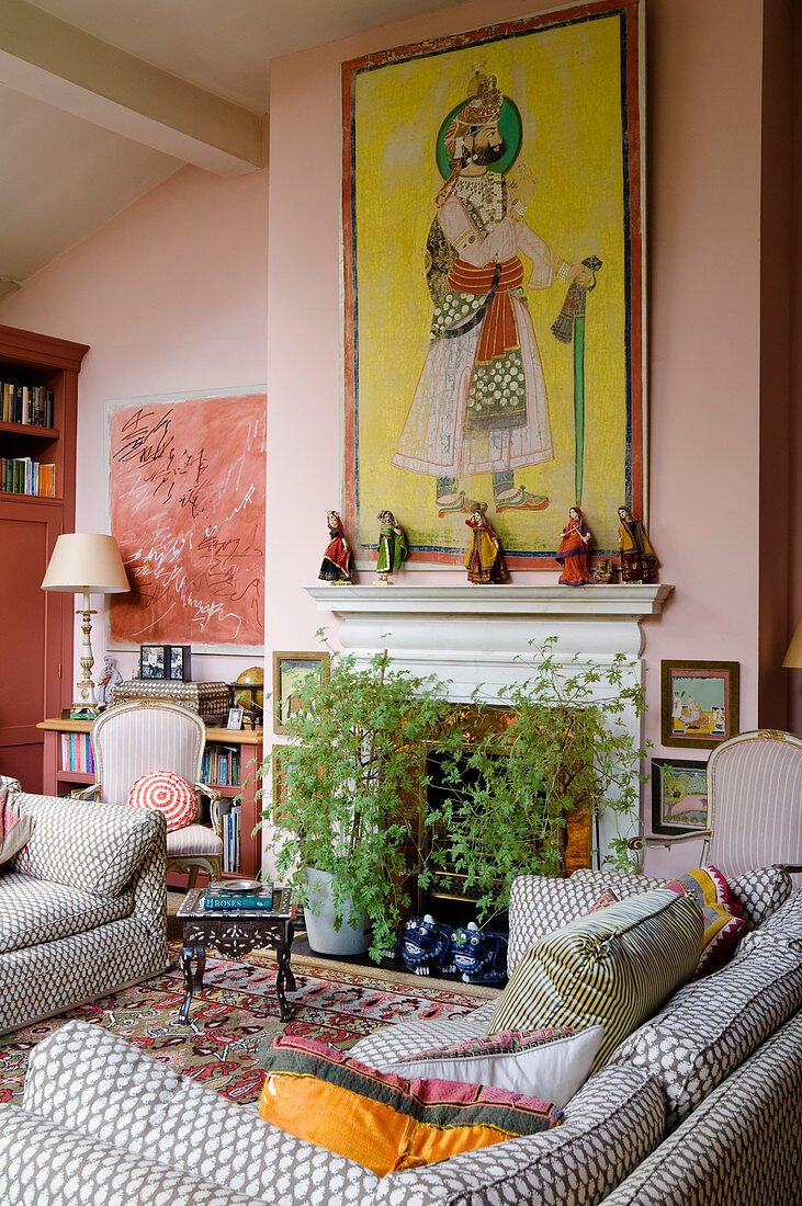 Oriental picture above fireplace in living room in shades of pink