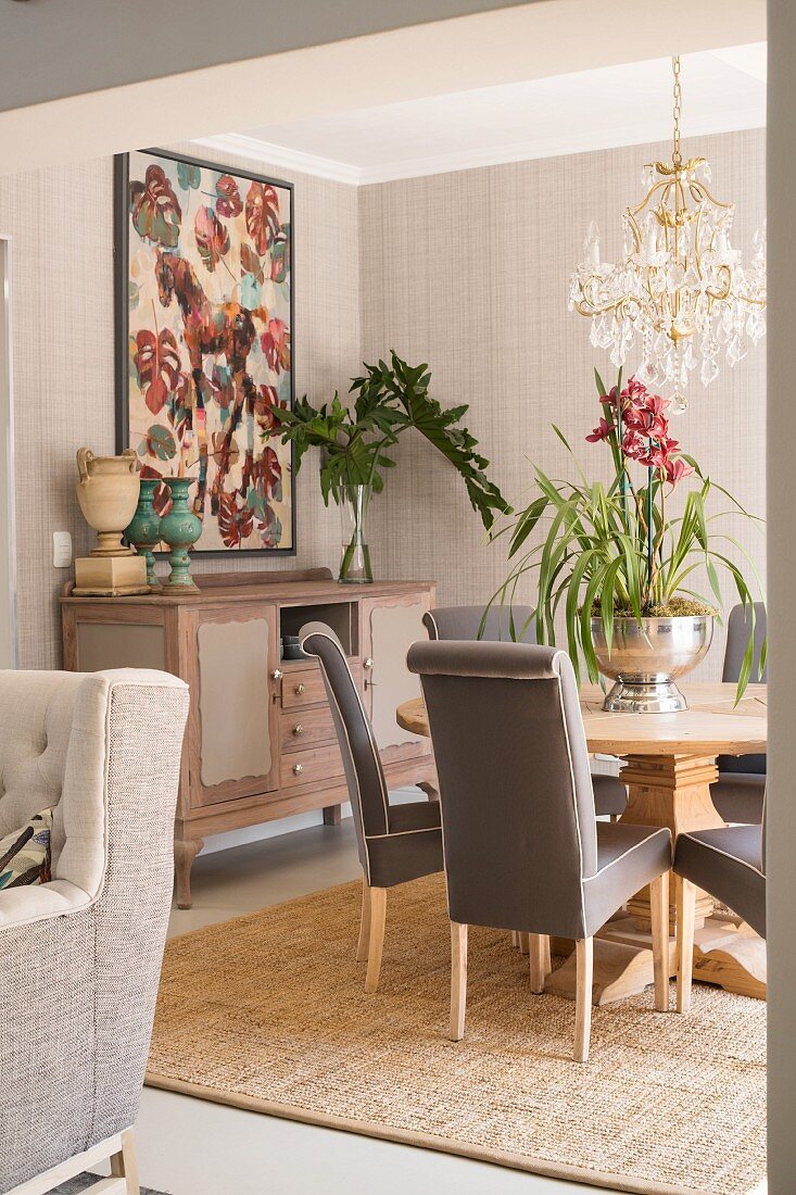Round table and grey upholstered chairs in elegant dining room