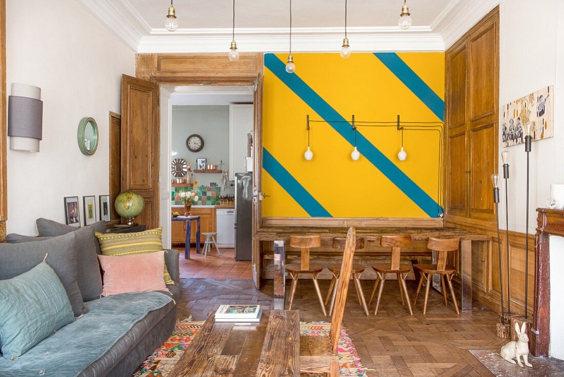 Brightly coloured wall and wood panelling in living room