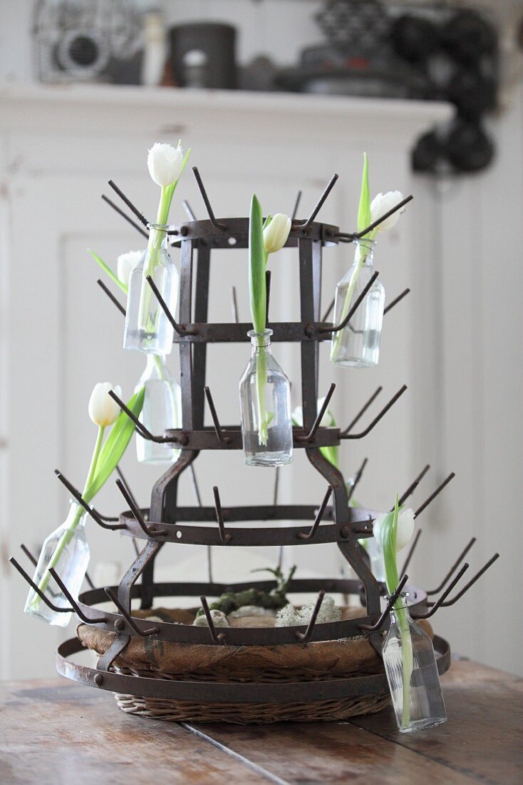 Bottle rack decorated with bottles and white tulips