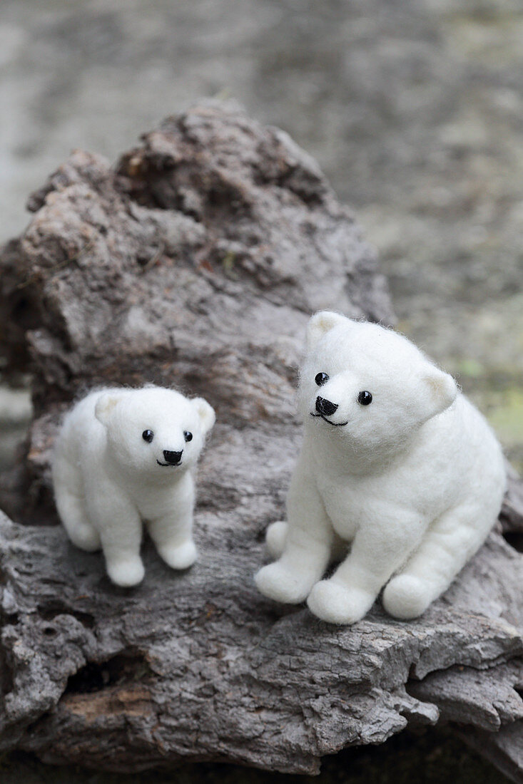 Two hand-made, felted, woollen polar bears