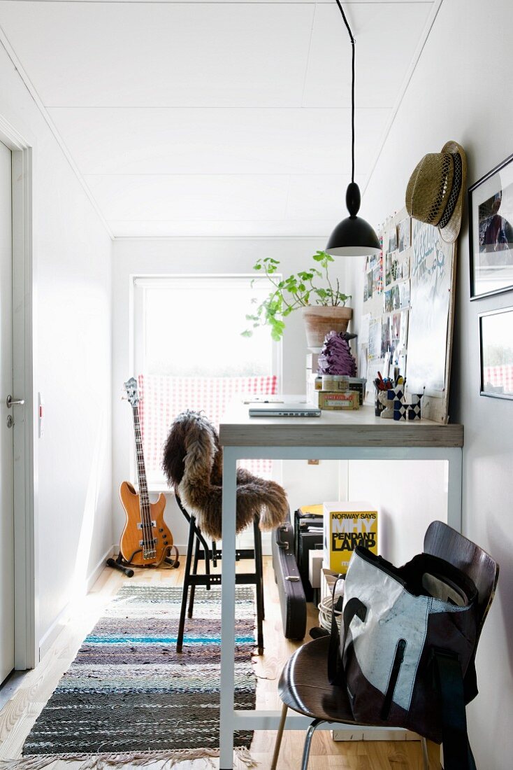 Workspace with tall table and tall stool in hallway
