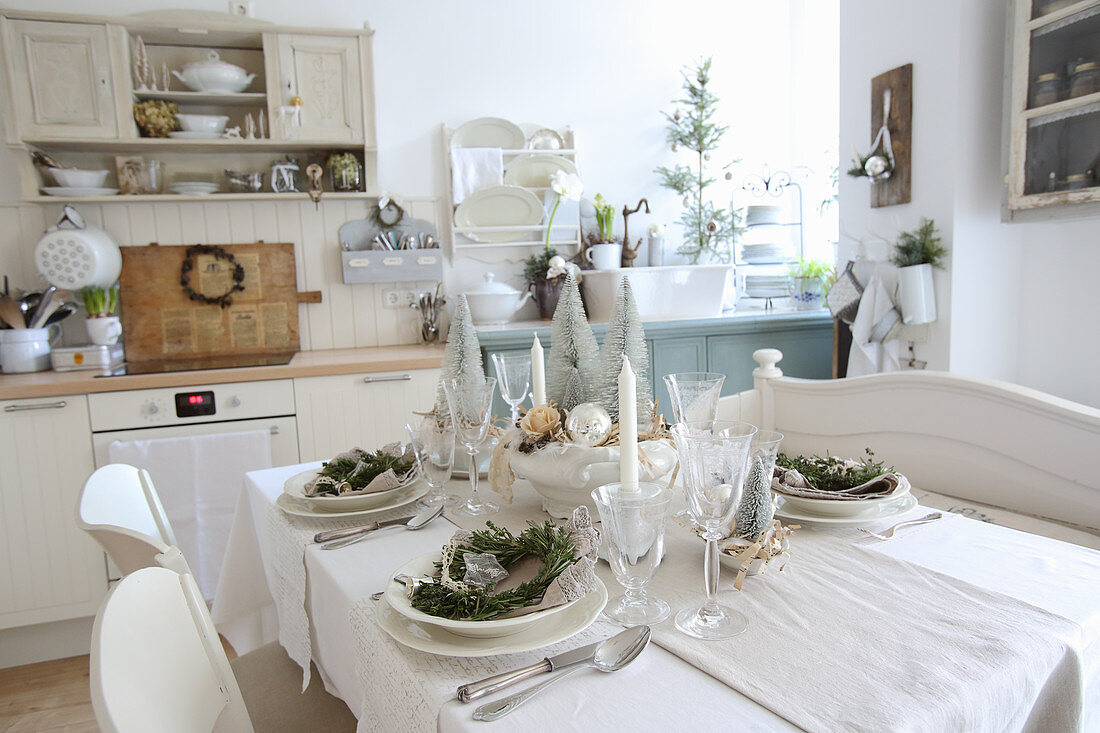 Festively set table in kitchen decorated for Christmas
