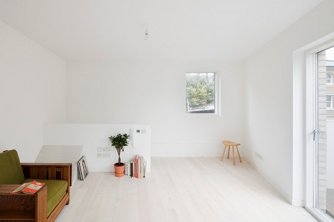 Bright attic room with white wooden floor
