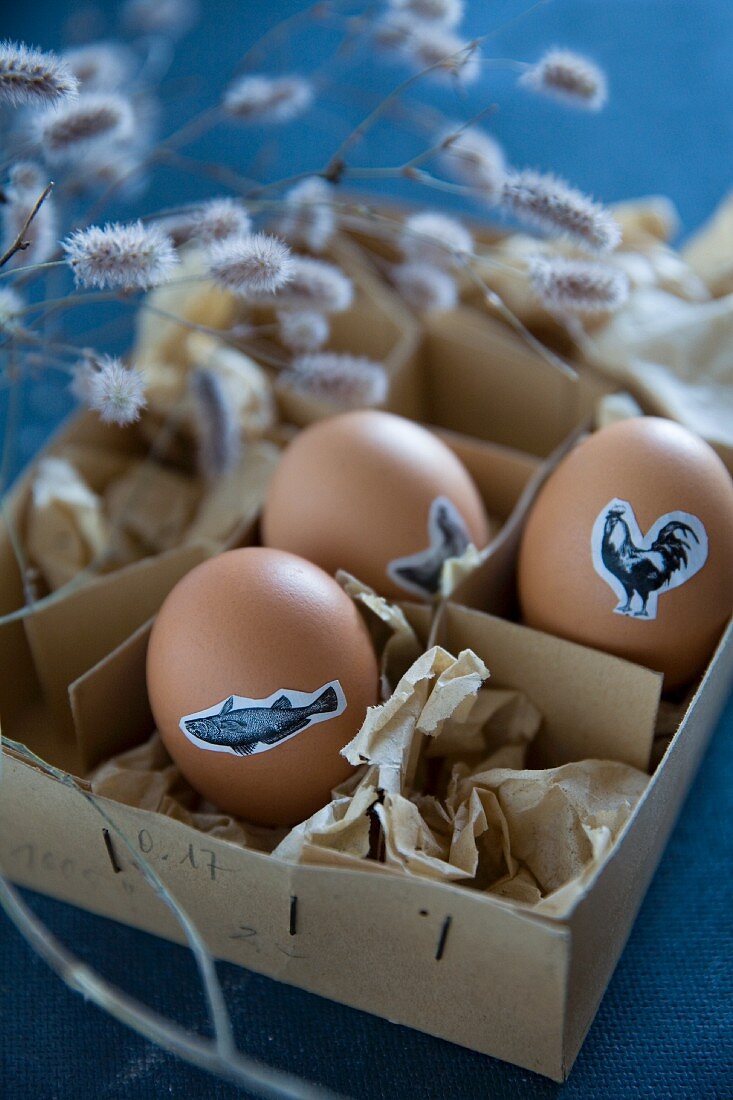 Eggs decorated for Easter with animal stickers in vintage box