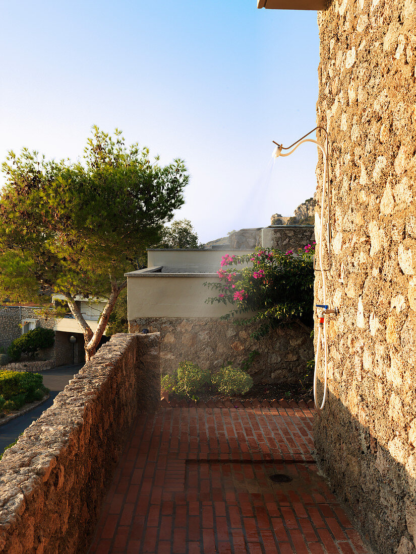 Außendusche an mediterraner Hauswand mit Naturstein