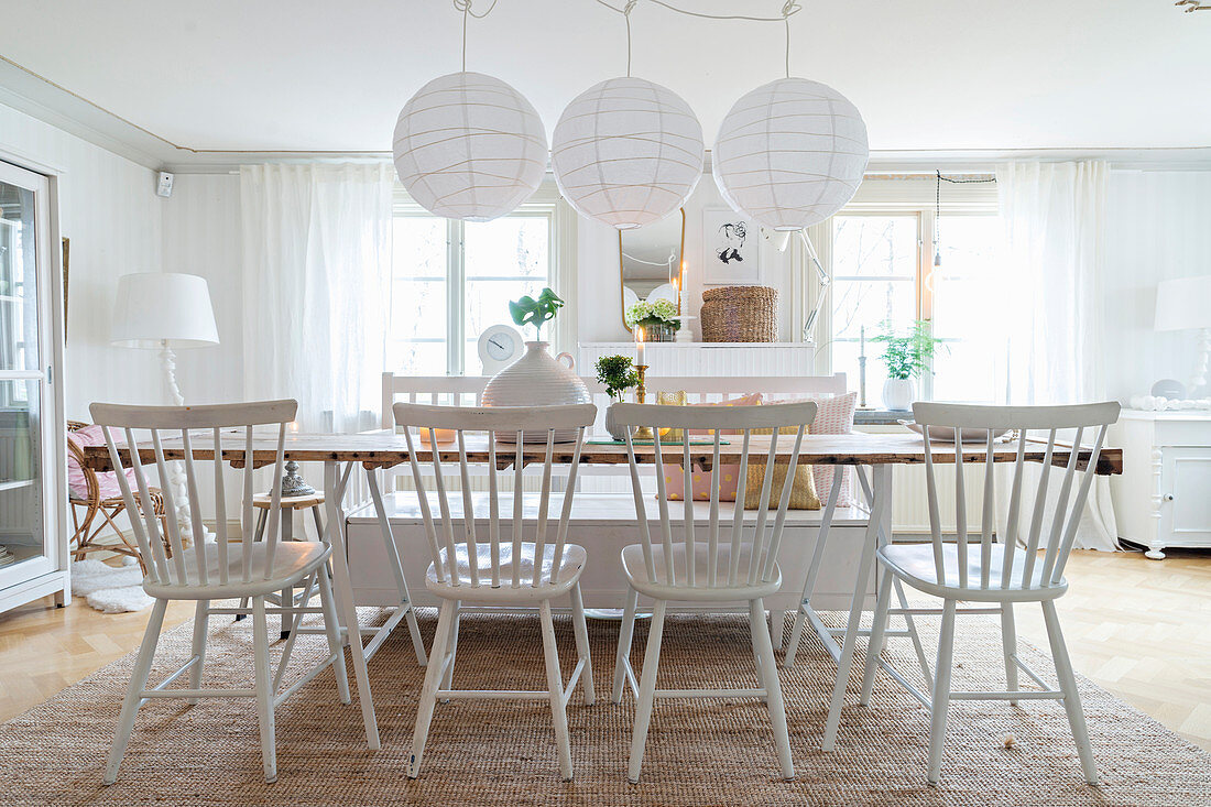 Windsor chairs and bench around long table in white dining room