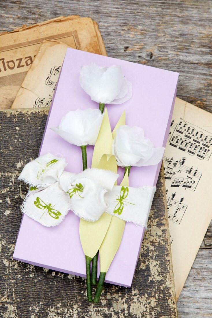 Gebastelte Papierblumen auf einer Schachtel aus Papier